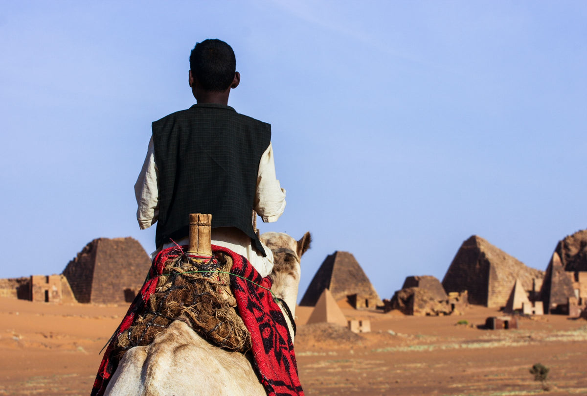 Camel rider near the Meroë pyramids, Sudan