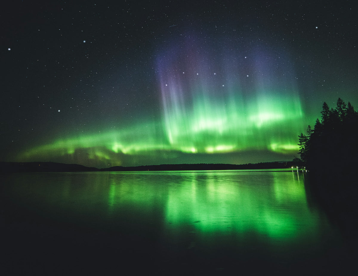 Aurora over a calm lake, Finland