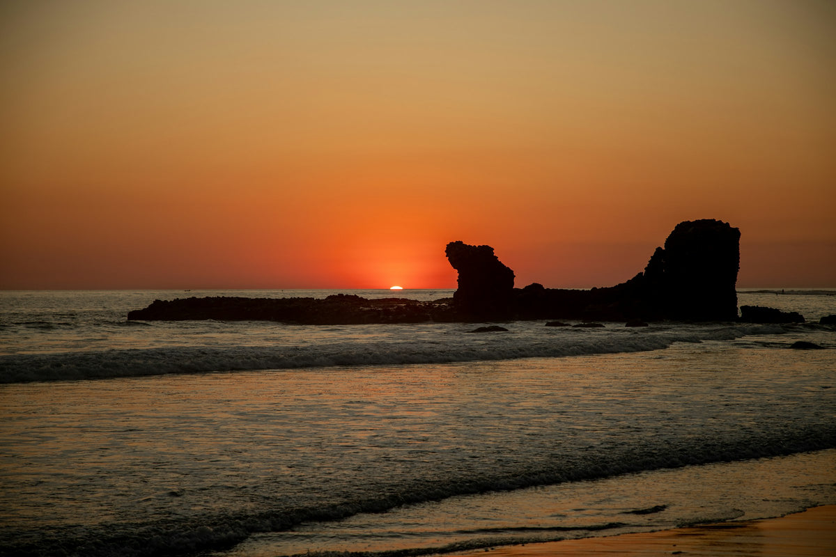 Rock formation at sunset on the Pacific coast, El Salvador
