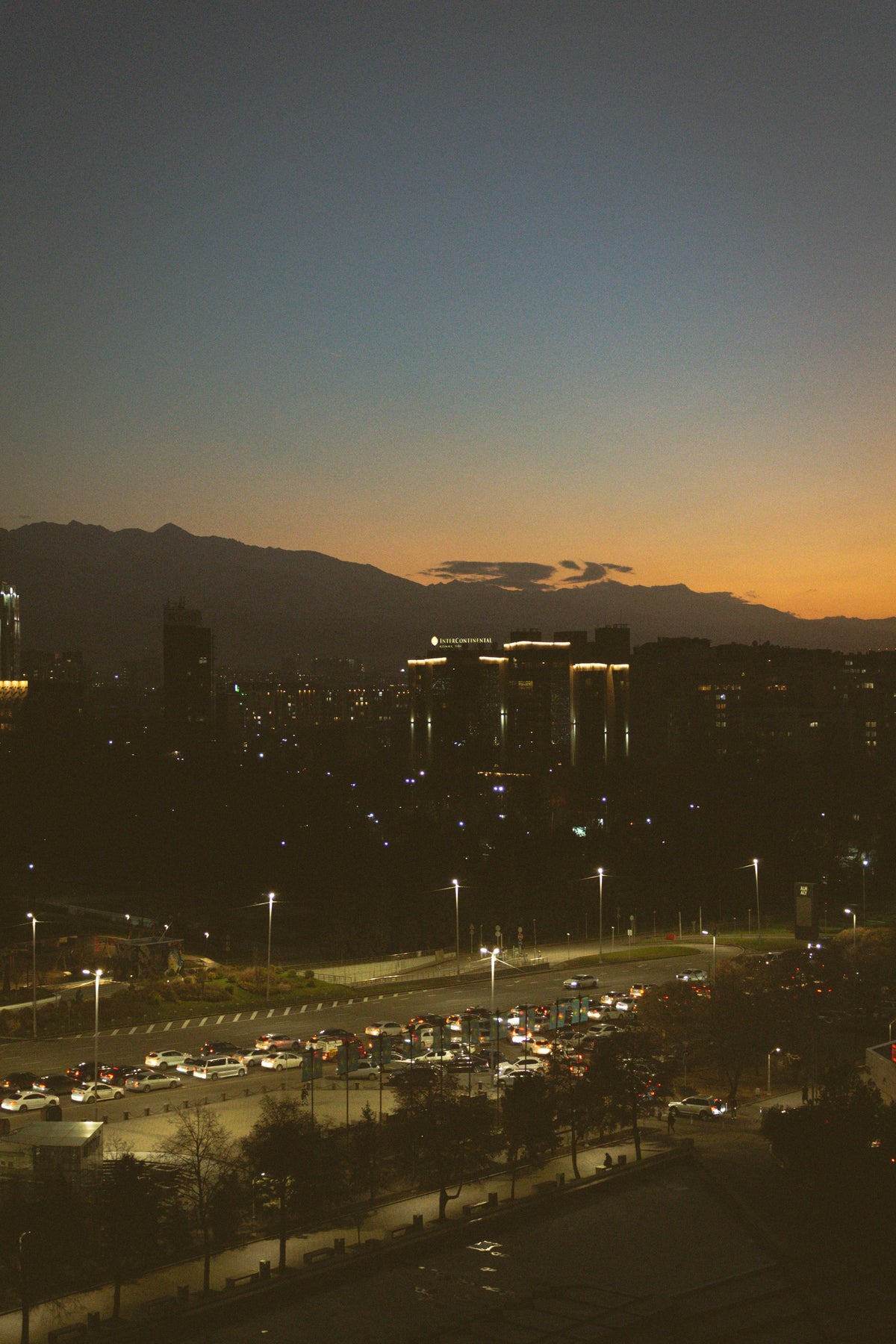Almaty at night with mountains in the background