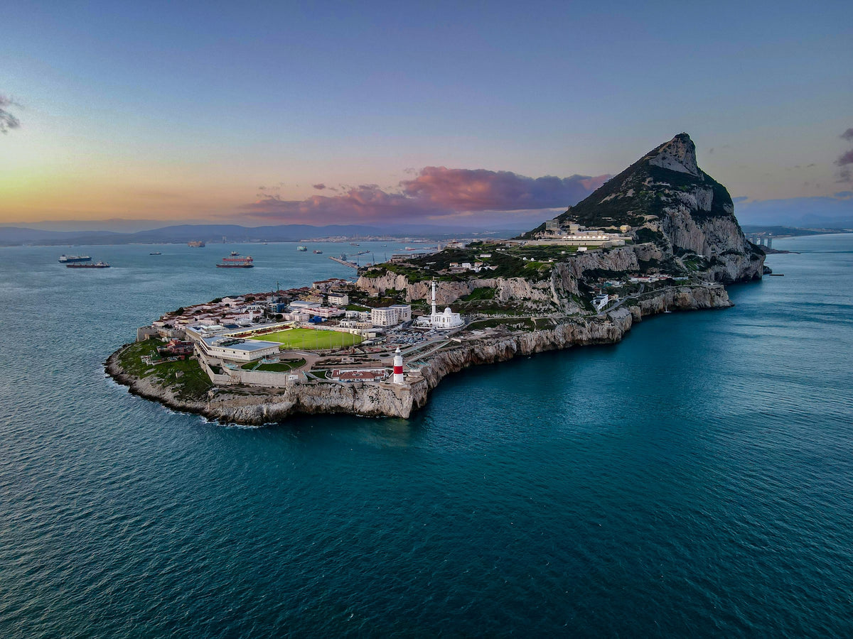 Rock of Gibraltar and lighthouse at sunset