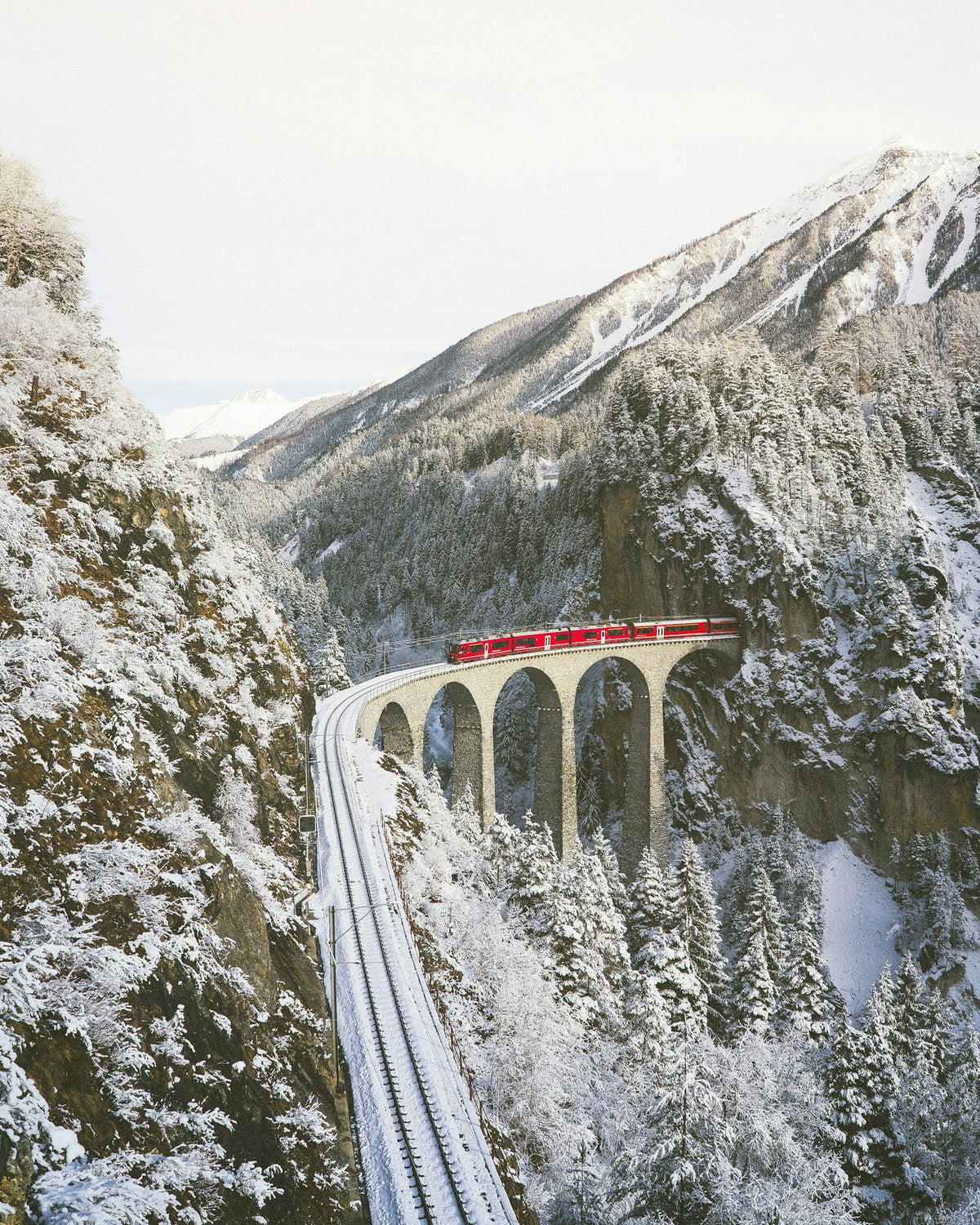 Red train through the Swiss mountains