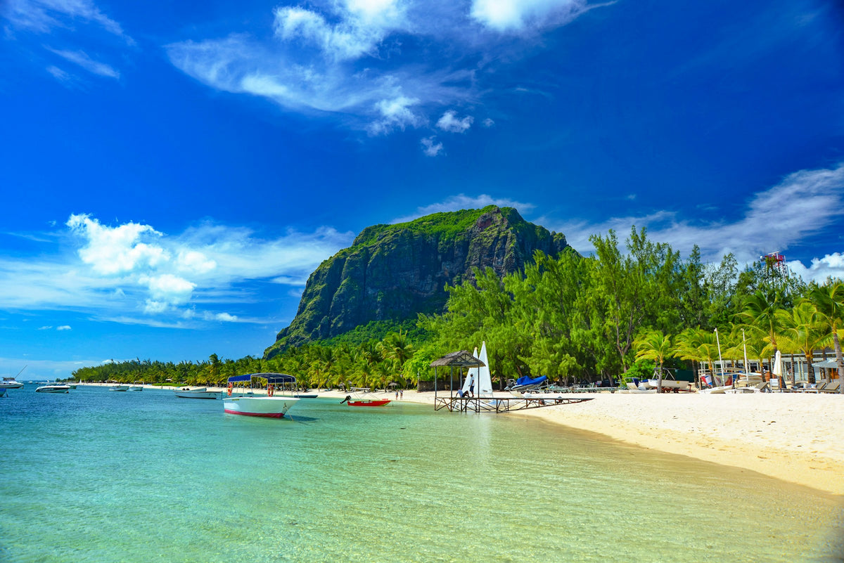 Boats below green mountains, Mauritius