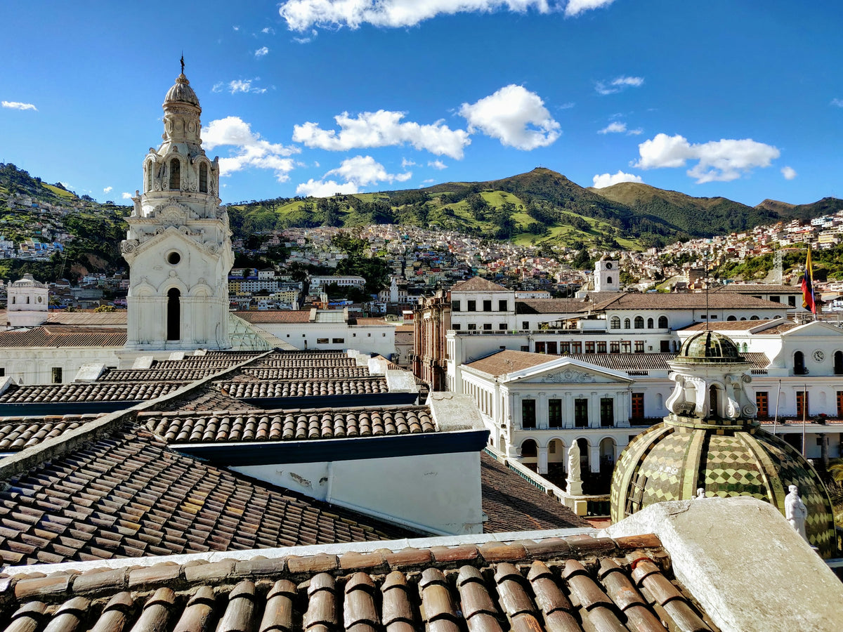 Colonial church below green mountains, Quito