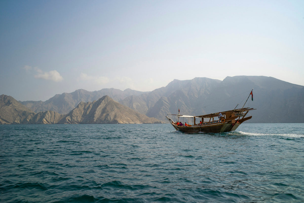 Traditional dhow near the mountains, Oman