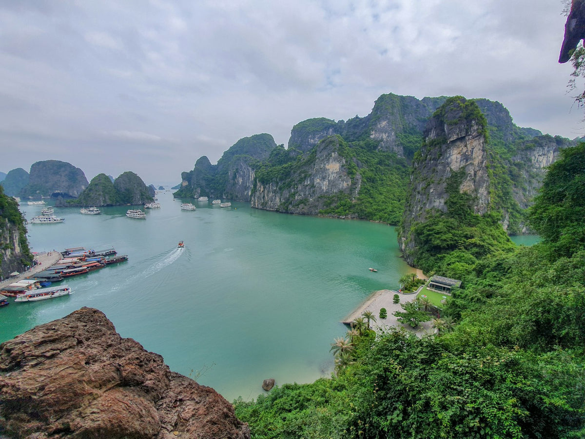 Boat on a river among green karst mountains, Vietnam